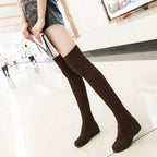 Black high flat over-the-knee stretch Martin boots by MANDOTOS, with sleek design and knee-high length visible.