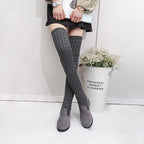 High flat over-the-knee stretch Martin boots by MANDOTOS, featuring sleek black design and knee-high length.