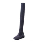 Mandotos high flat over-the-knee stretch Martin boots showcasing sleek black leather and knee-high design.