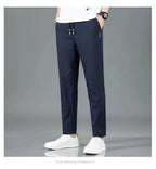 Mandotos Ice Silk men's summer black and gray casual pants with elastic waistband, breathable straight-leg design for outdoor wear.