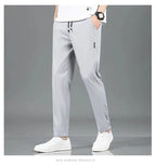 Mandotos Ice Silk men's summer casual pants in black and gray, featuring a breathable, elastic, straight-leg design.