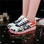 Mandotos LED light-up sneakers with sparkling soles, showcasing the illuminated design and vibrant style for active wear.