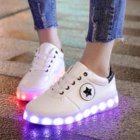 Mandotos LED light-up sneakers glowing with colorful lights, showcasing their sparkling, stylish design for vibrant footwear.