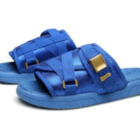 Unisex beach slides by MANDOTOS INTERNATIONAL with stylish design and comfortable straps, perfect for casual seaside wear.