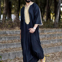 Elegant men's black linen robe by MANDOTOS INTERNATIONAL, showcasing a comfortable fit and stylish design on a model.