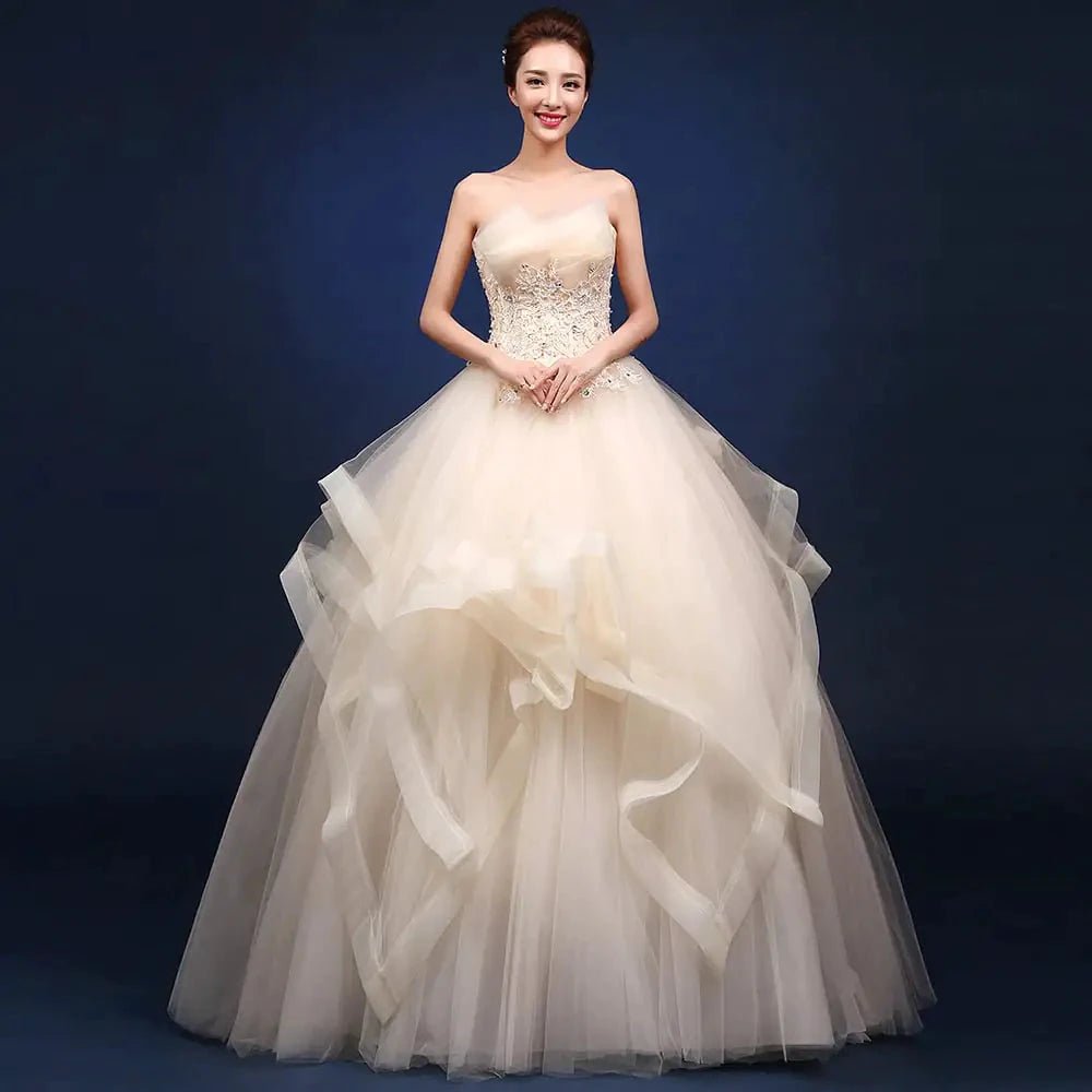 Elegant one-shoulder bridal gown by MANDOTOS INTERNATIONAL featuring flowing fabric and intricate detailing for wedding attire.