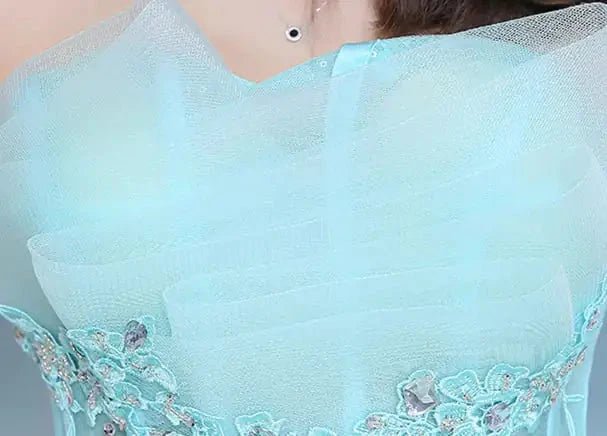 Elegant one-shoulder bridal gown by MANDOTOS INTERNATIONAL featuring flowing fabric and sophisticated design for weddings.