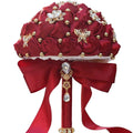 Dark red Eternal Rose bridal bouquet by MANDOTOS INTERNATIONAL, featuring preserved roses arranged in a romantic floral display.