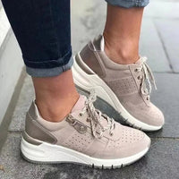 Fashionable lace-up sneakers with zipper detail and medium heel height by MANDOTOS INTERNATIONAL, shown from a side view.