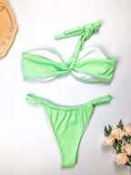 Eco-friendly women's one-shoulder bikini set by MANDOTOS INTERNATIONAL, featuring a sexy split design in recycled fabric.