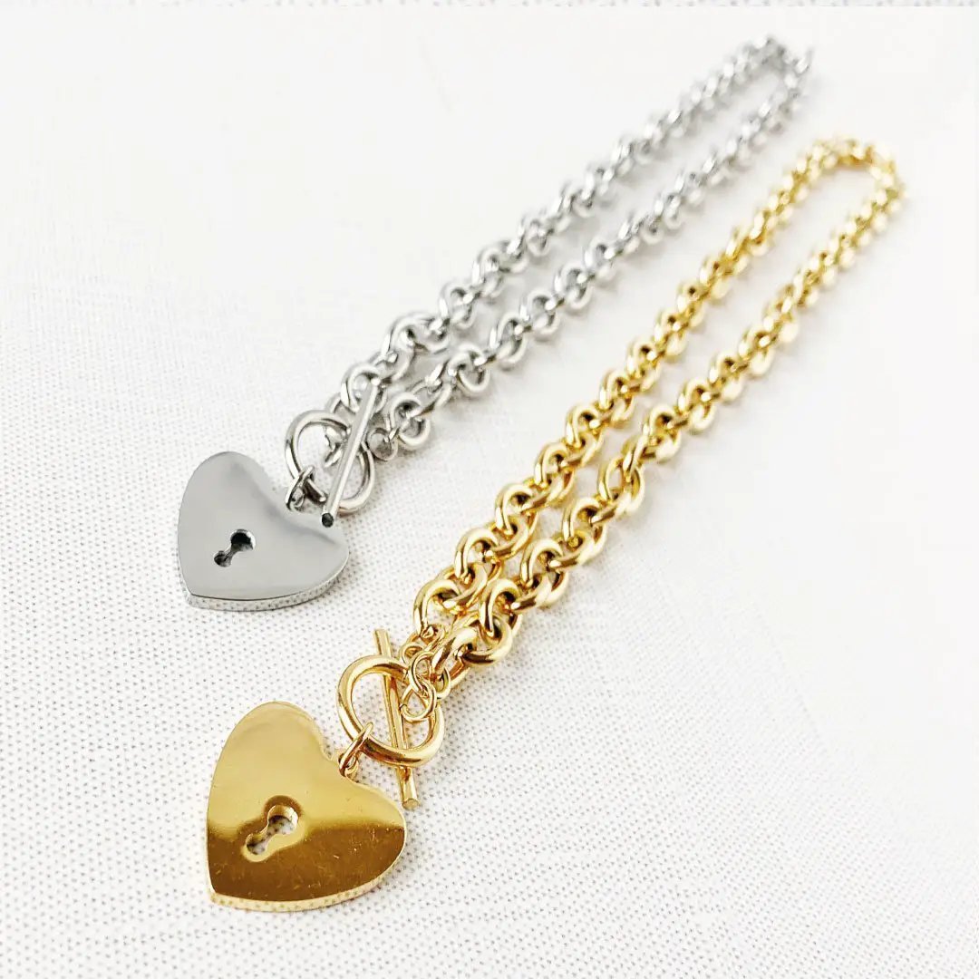 Heart-shaped key toggle necklace by MANDOTOS INTERNATIONAL featuring a silver chain and a decorative heart key pendant.