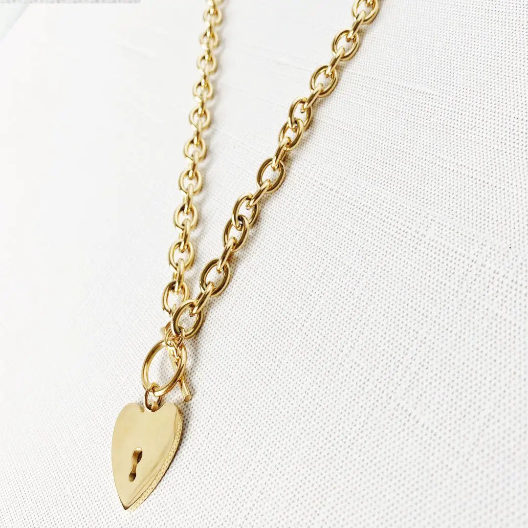 Heart-shaped key toggle necklace by MANDOTOS INTERNATIONAL featuring a delicate chain and a detailed heart key pendant.
