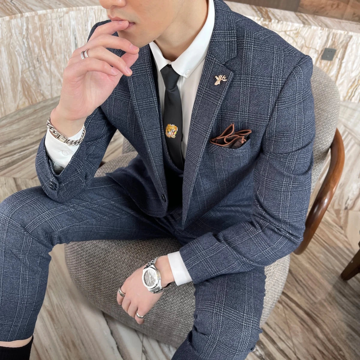 British Korean style plaid men's 3-piece business casual suit set by MANDOTOS INTERNATIONAL, shown on a hanger with jacket, vest, and pants.