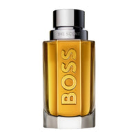 Hugo Boss THE SCENT For Men 1.6oz perfume bottle by Mandotos International, sleek glass container with dark liquid inside.