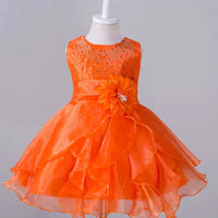 Kids glam dresses and gowns by MANDOTOS INTERNATIONAL, featuring colorful, sparkly designs for special occasions.