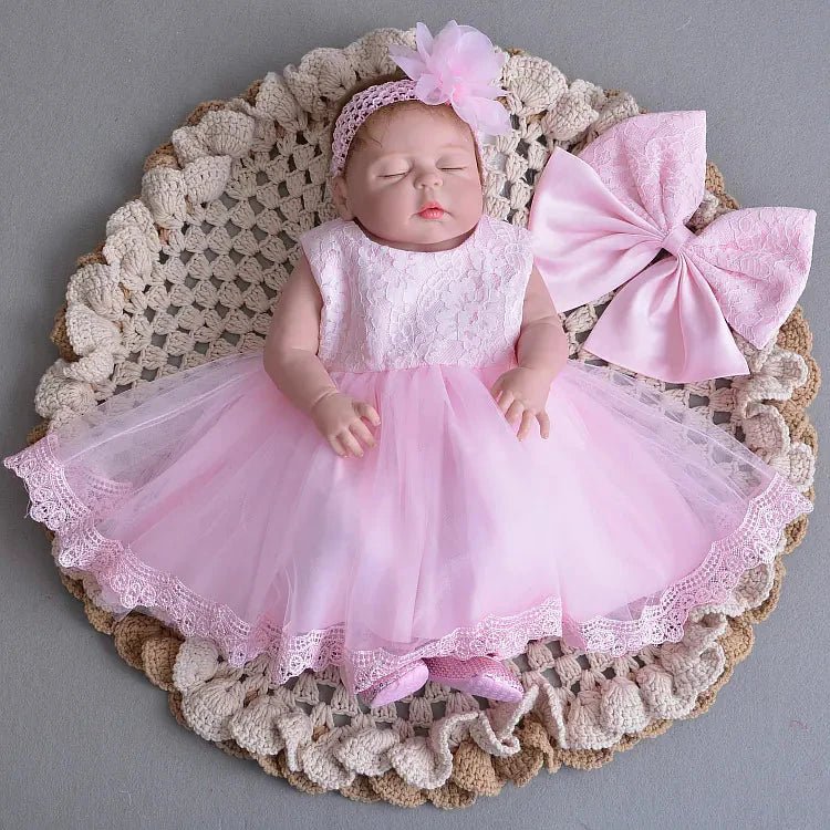 Little Princess gown by MANDOTOS INTERNATIONAL featuring a pink dress with floral accents, perfect for special occasions.