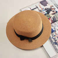 Mandotos Island Breeze Boater hat with wide brim, lightweight straw material, and decorative ribbon for sun protection and style