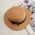 Mandotos Island Breeze Boater hat in natural straw with a wide brim and black ribbon for sun protection and stylish summer wear.