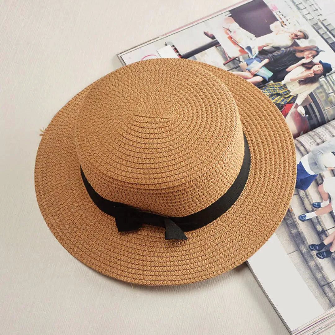 Mandotos Island Breeze Boater hat in natural straw with a wide brim and black ribbon for sun protection and stylish summer wear.