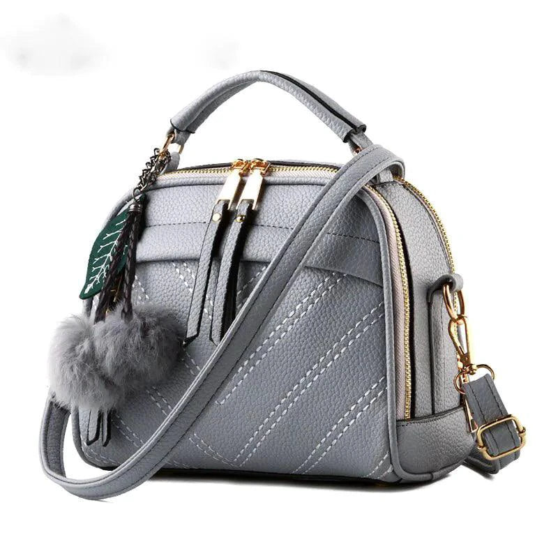 Luxury ladies' leather handbag by MANDOTOS showcasing elegant design, smooth leather surface, and stylish gold-tone hardware.