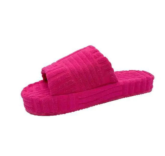 Cozy ladies' plush slip-on slippers by MANDOTOS with soft, fluffy material and comfortable interior for indoor wear.