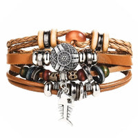 Layered leather charm bracelet by MANDOTOS featuring multiple leather strands and metal charms, stylish and casual accessory.