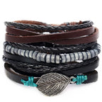 Layered leather charm bracelet by MANDOTOS featuring multiple leather straps and metal charms on a neutral background.
