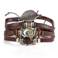 Layered leather charm bracelet by MANDOTOS featuring multiple leather strands and decorative metal charms.