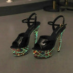 Shiny black leather stiletto heels by MANDOTOS with pointed toes and sleek design for elegant footwear.
