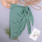 Mandotos LuxeWave chiffon beach wrap draped over a woman, showcasing its lightweight, chic, and versatile cover-up design for beach or pool.