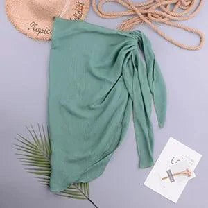 Mandotos LuxeWave chiffon beach wrap draped over a model, showcasing effortless chic and versatile style for beach or poolside wear.