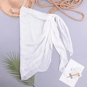Mandotos LuxeWave chiffon beach wrap draped over a model, showcasing its lightweight, flowy fabric and versatile style for beach or casual wear.