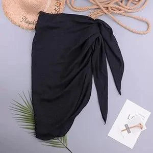 Mandotos LuxeWave chiffon beach wrap, lightweight and versatile cover-up, draped over a model in a sunny beach setting.