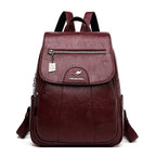 Mandotos luxury embossed leather backpack with sleek design, top handle, and adjustable shoulder straps featuring textured leather surface.