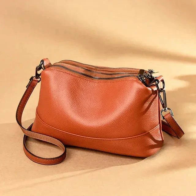 Luxury genuine leather handbag by MANDOTOS, featuring sleek design and quality craftsmanship with topstitched details.