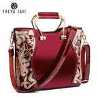 Mandotos elegant floral leather tote in burgundy with embroidered details and a detachable crossbody strap.