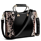 Mandotos elegant floral leather tote in burgundy with embroidered design and crossbody strap detail.