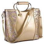 Mandotos floral leather tote bag in burgundy with embroidered floral design and an adjustable crossbody strap.