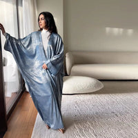 Mandotos Muslim robe abaya in black with intricate embroidery, flowing fabric, and long sleeves, elegant Islamic modest wear.