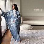 Mandotos Muslim robe abaya in black with intricate embroidery, flowing fabric, and long sleeves, elegant Islamic modest wear.