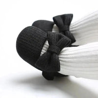 Soft newborn shoes by Mandotos with flexible fabric and gentle sole, perfect for delicate baby feet.