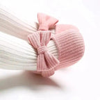 Soft newborn shoes from MANDOTOS in pastel colors, featuring a cozy design with flexible soles for delicate baby feet.