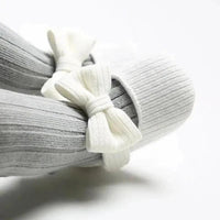 Soft newborn shoes from MANDOTOS, featuring cozy fabric and gentle sole, designed for delicate baby feet.