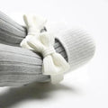 Soft newborn shoes from MANDOTOS, featuring cozy fabric and gentle sole, designed for delicate baby feet.
