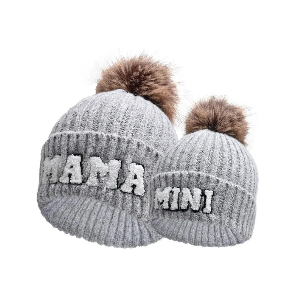 Set of three matching parent-child beanie hats by MANDOTOS, perfect for winter, including mama, papa, and baby in cozy knit styles.