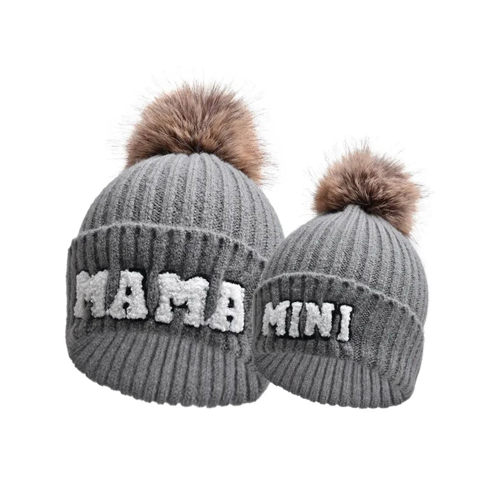 Matching parent and child beanie hats set by MANDOTOS, including three cozy winter knit hats for mama, papa, and baby.