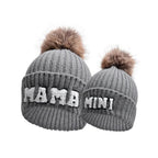Matching parent and child beanie hats set by MANDOTOS, including three cozy winter knit hats for mama, papa, and baby.