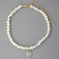 Mandotos round medal pearl necklace with irregular pearls, elegant jewelry piece showcasing a sophisticated design and natural pearl texture.