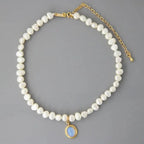 Mandotos round medal pearl necklace with irregular pearls, elegant jewelry piece showcasing a sophisticated design and natural pearl texture.