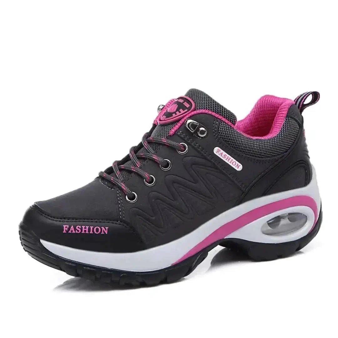 Mandotos running shoes in black and white with cushioned soles and breathable mesh uppers, designed for comfort and performance.